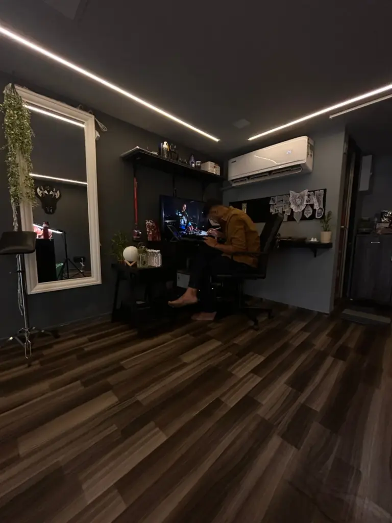 Artist sketching a custom tattoo design at the studio desk, Rays Tattoo Studio